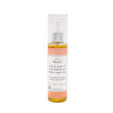 Bottle of organic calendula oil for eczema on a white background.