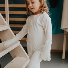 Atopic dermatitis pajama with closed mittens and button back closure, shown from behind