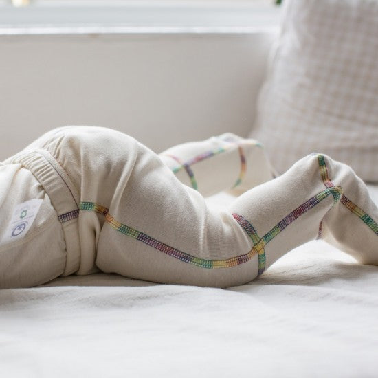 Close up of the pants with feet on a baby laying on his belly.
