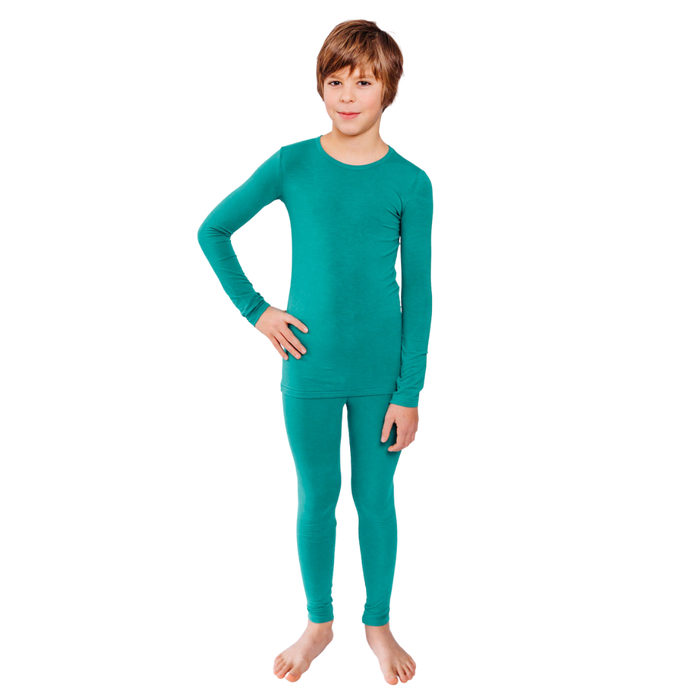 Boy with hand on hip wearing teal Remeywear long sleeve shirt and long pants.
