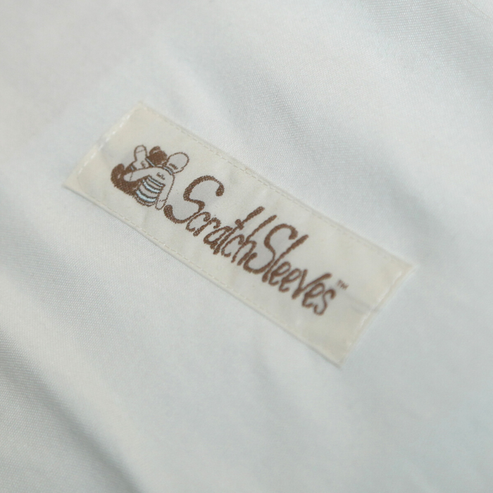Close up of rectangularly shaped ScratchSleeves logo with baby and teddy bear embracing.